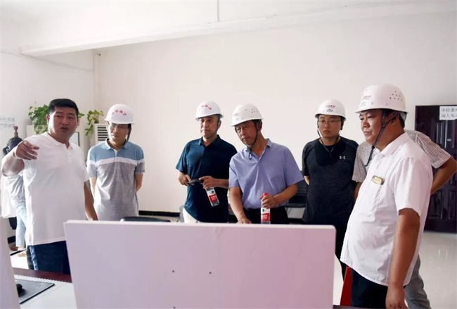 團(tuán)隊(duì)考察生產(chǎn)線上的中控室